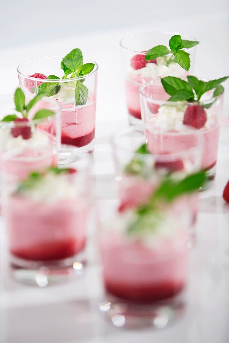 Glasses of yogurt with raspberries and mint leaves