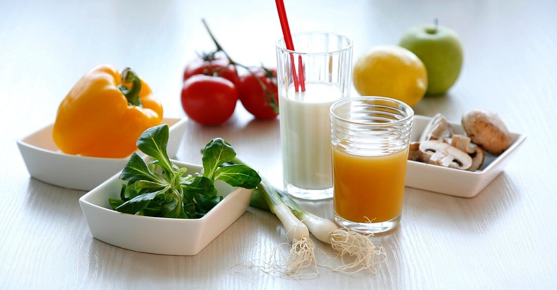 Still life with vegetables, fruit, milk and fruit juice