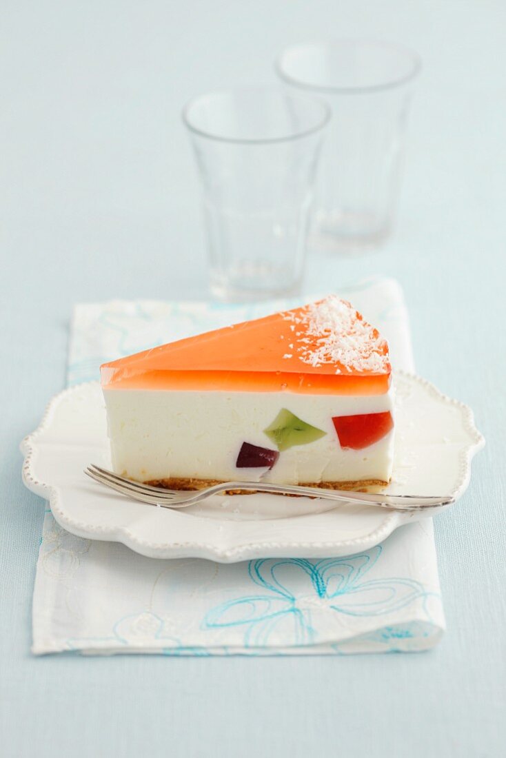 A slice of cheesecake with fruit jelly