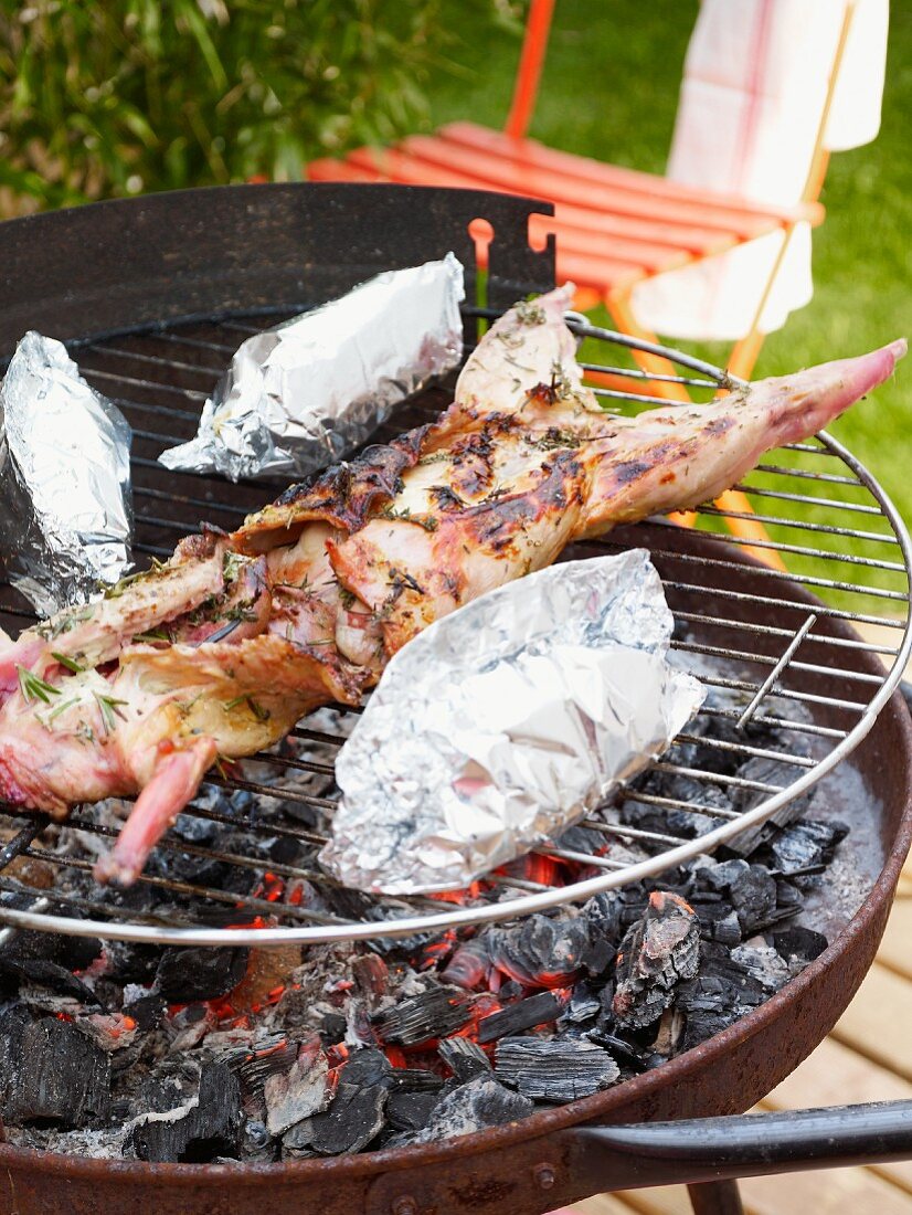 Grilled rabbit with thyme and baked potatoes (wrapped in foil)