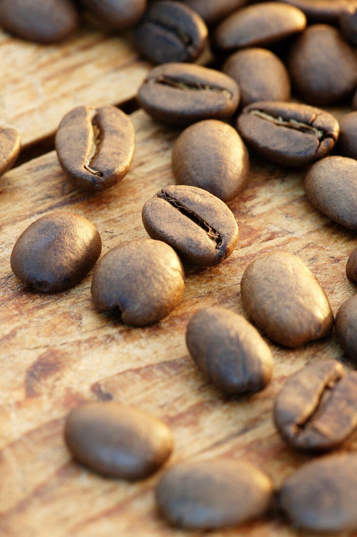 Roasted coffee beans on a wooden surface