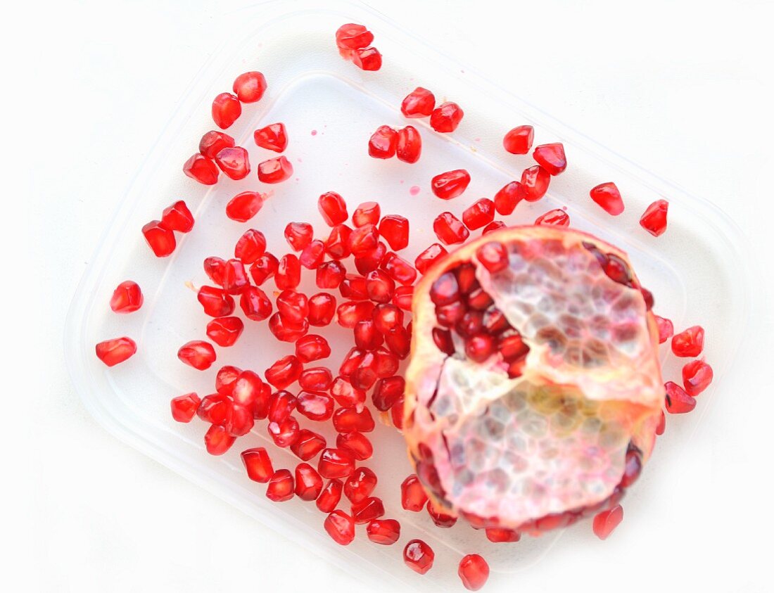 Sliced pomegranate with pomegranate seeds