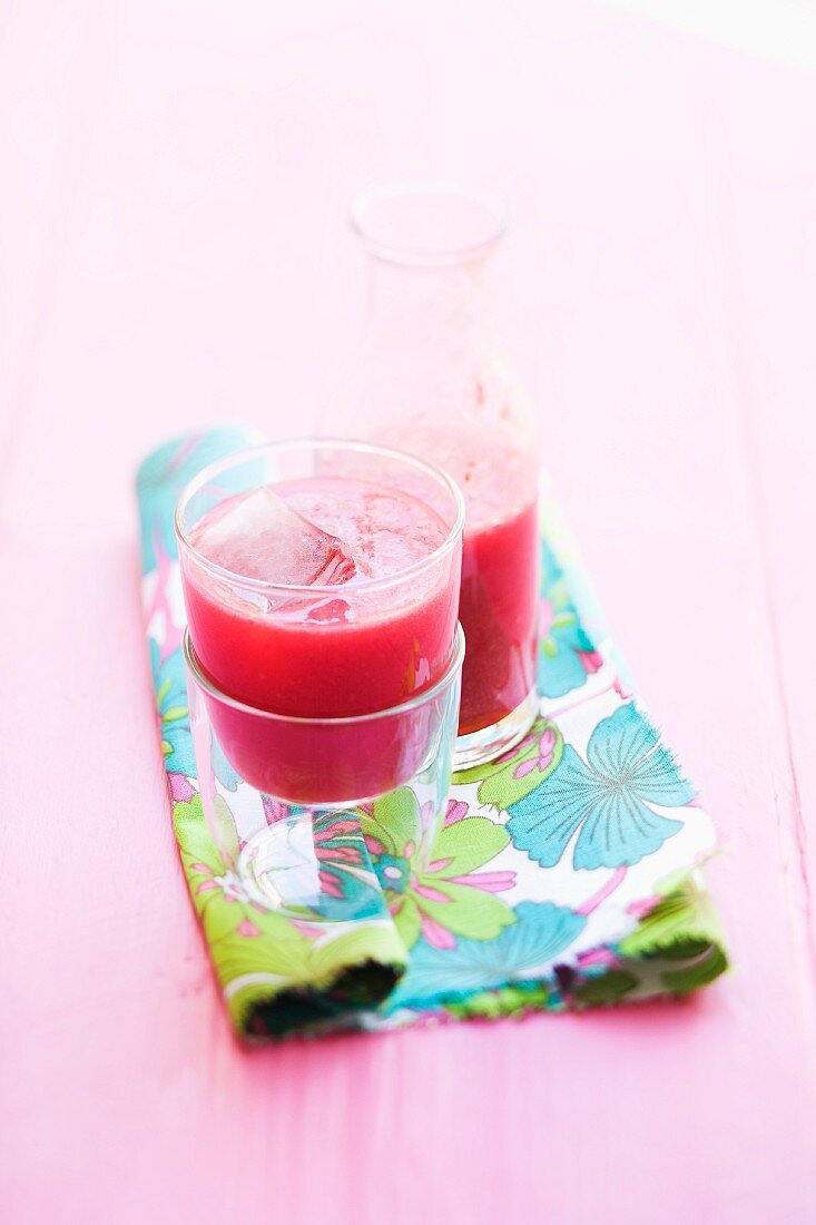 Raspberry juice with ice cubes