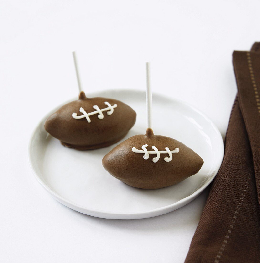 Two Football Cake Pops on a Plate