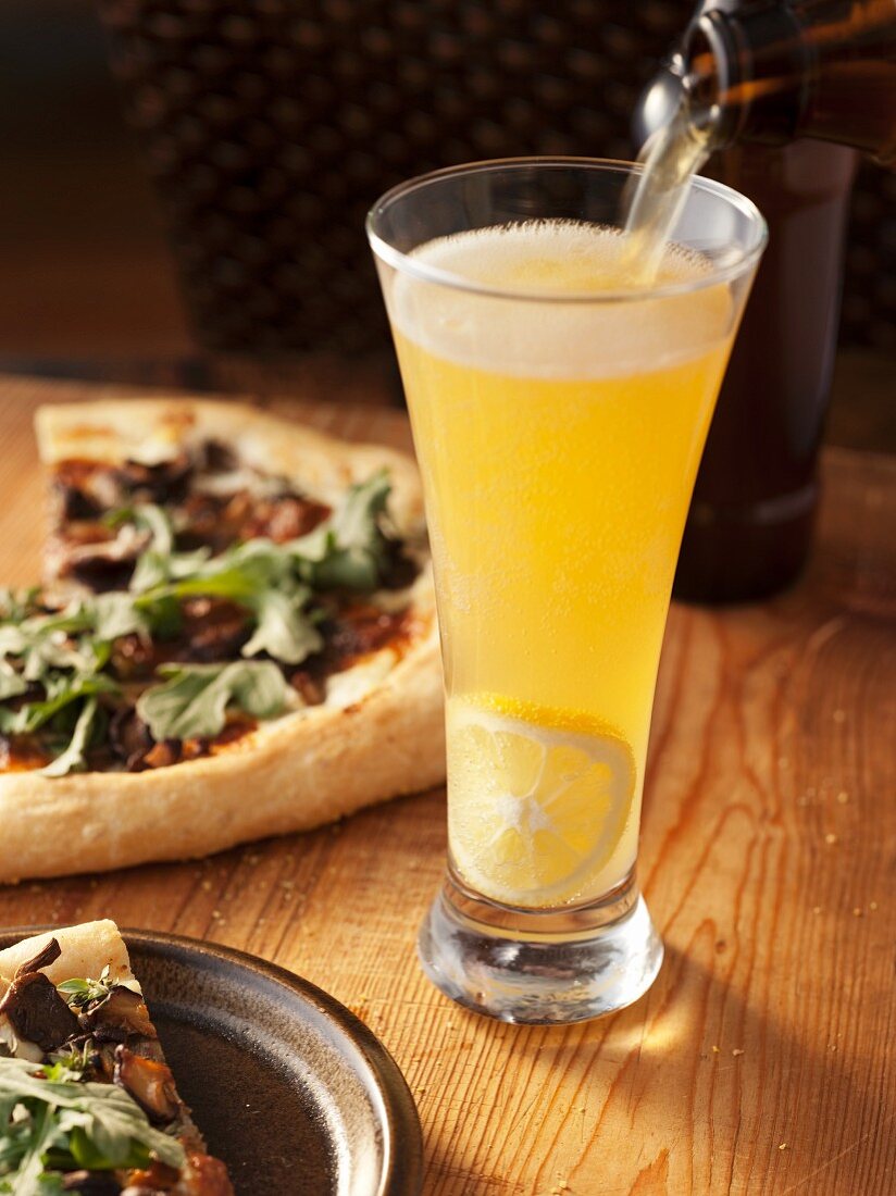 Pouring Beer into a Glass of Panache; Arugula Pizza