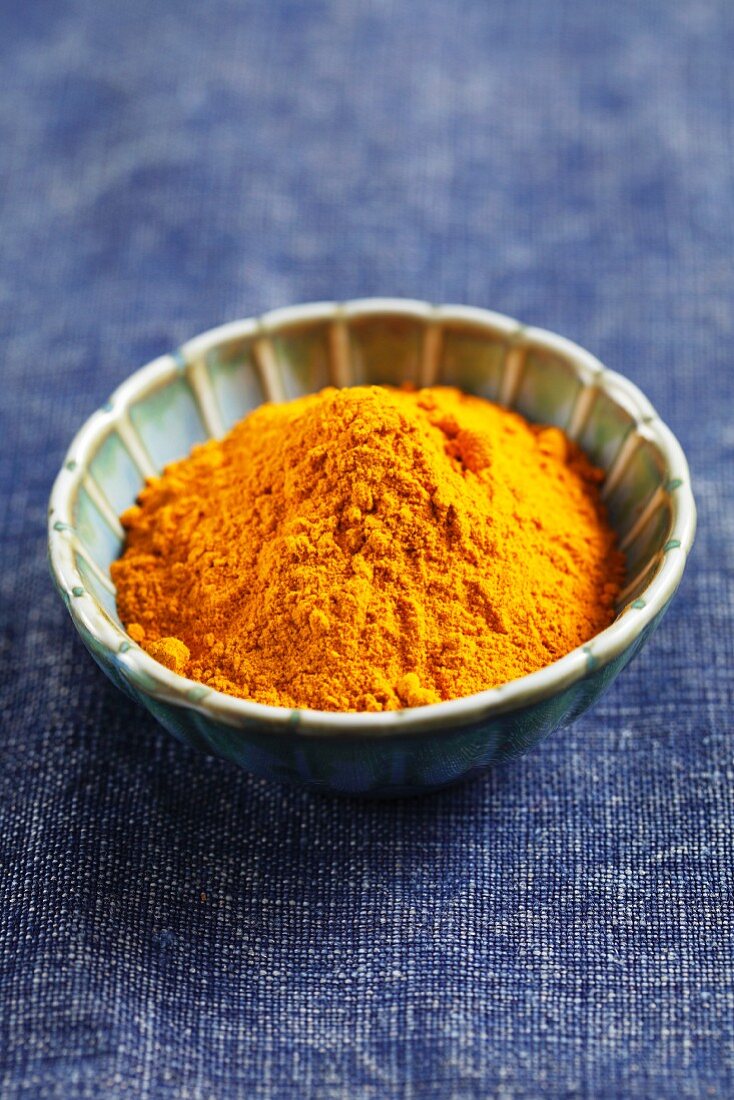 Ground turmeric in a small bowl