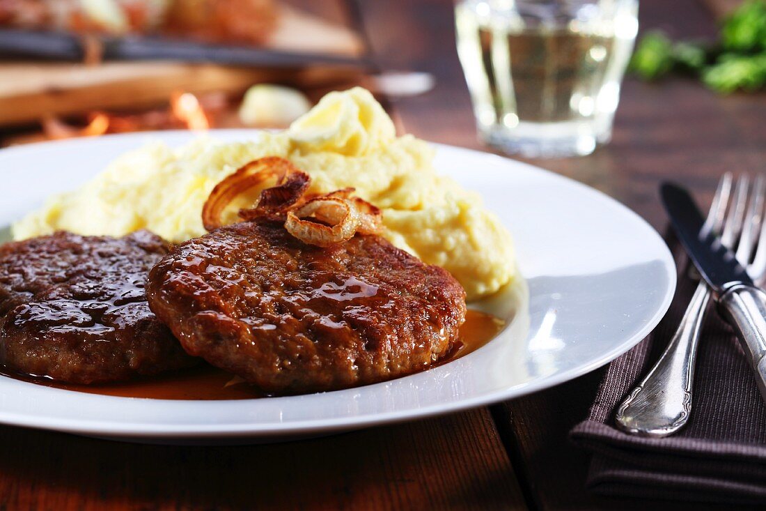 Frikadellen (German meat patties) with fried onions and mashed potato