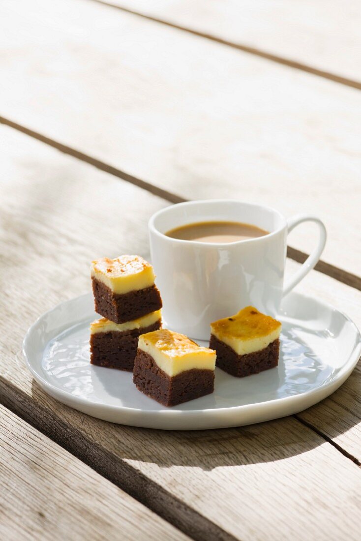 Cheesecake brownies with a cup of coffee