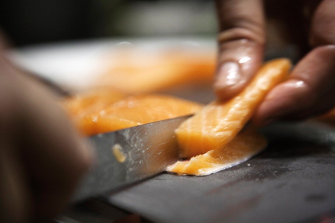 Raw salmon being cut