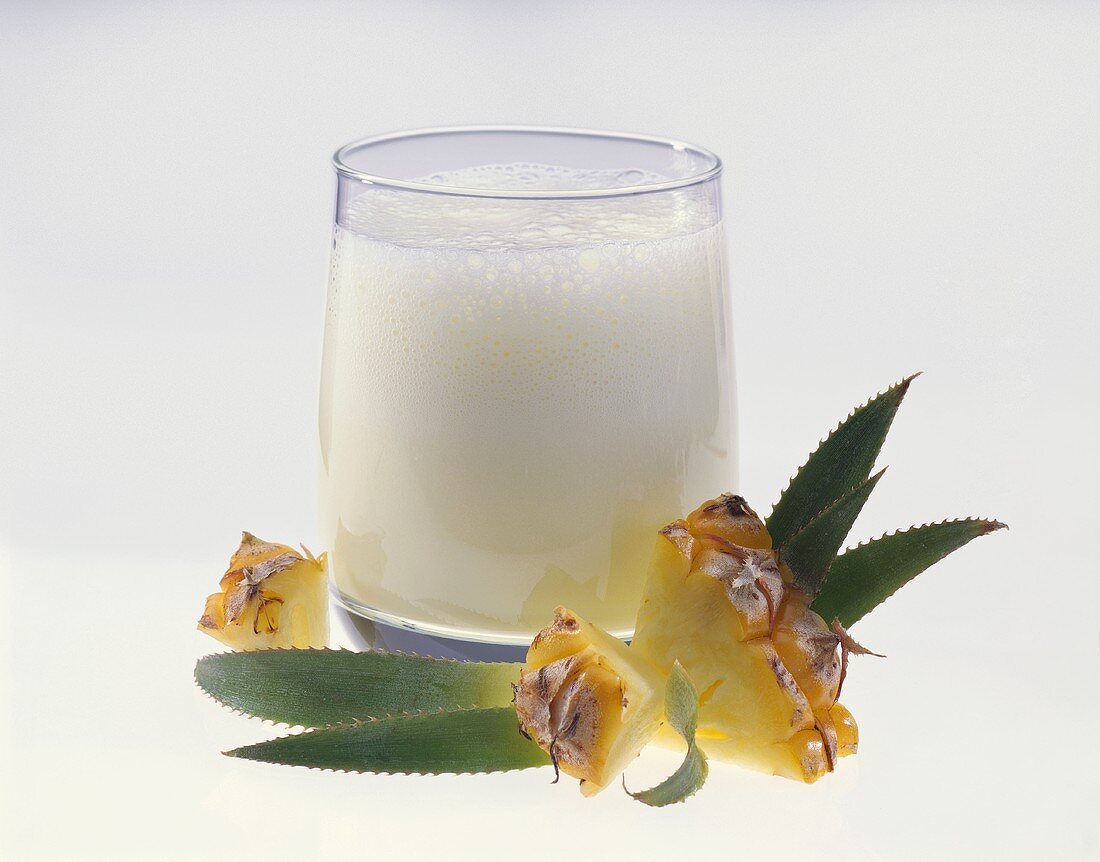 Pineapple Milkshake in a Glass with Chunks of Pineapple