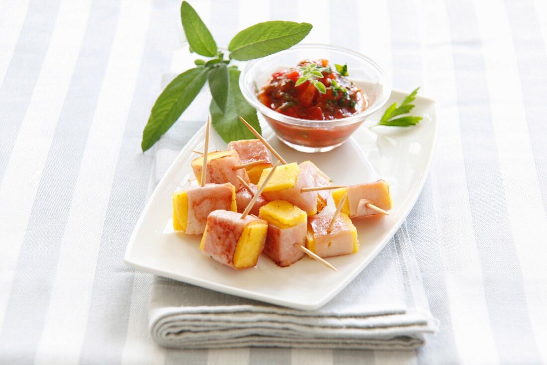 Polenta and ham cubes with tomato dip