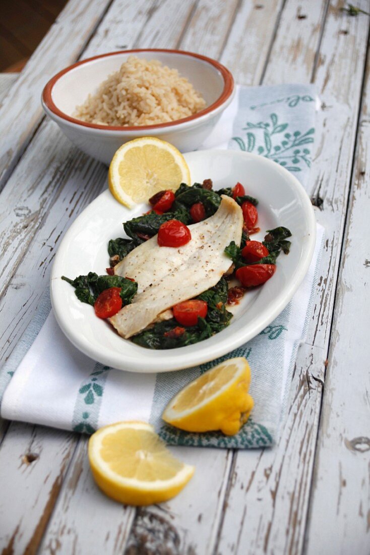 Zander fillet with cherry tomatoes on a bed of spinach