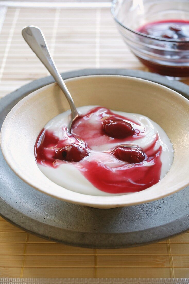 A dessert of yoghurt with cherries
