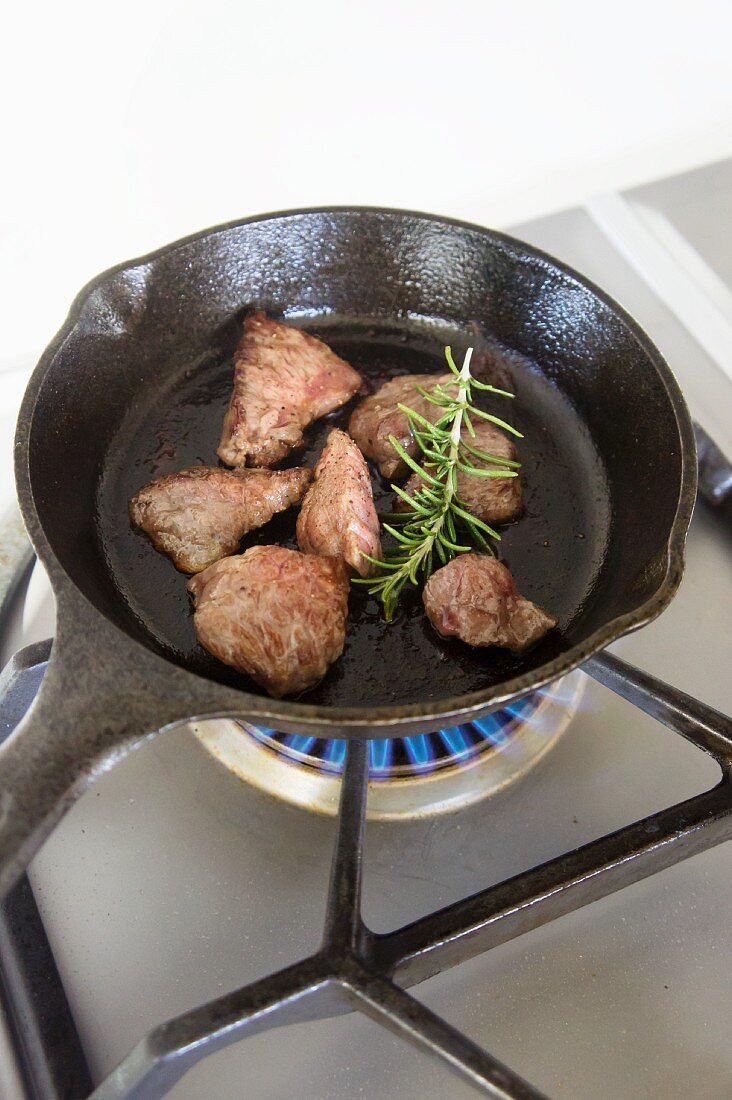 Wagyu beef with rosemary in a pan
