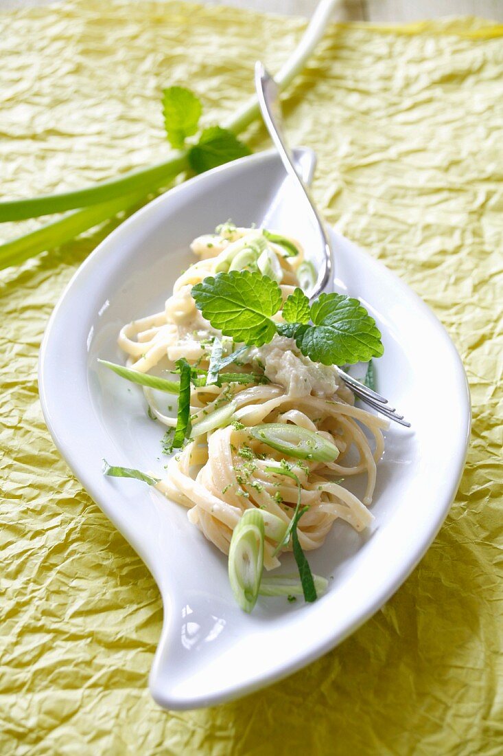 Ribbon pasta with spring onions, lime sauce and lemon balm