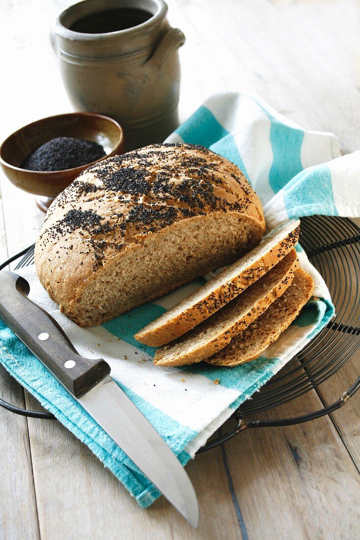 Wholemeal bread with poppy seeds, partly sliced
