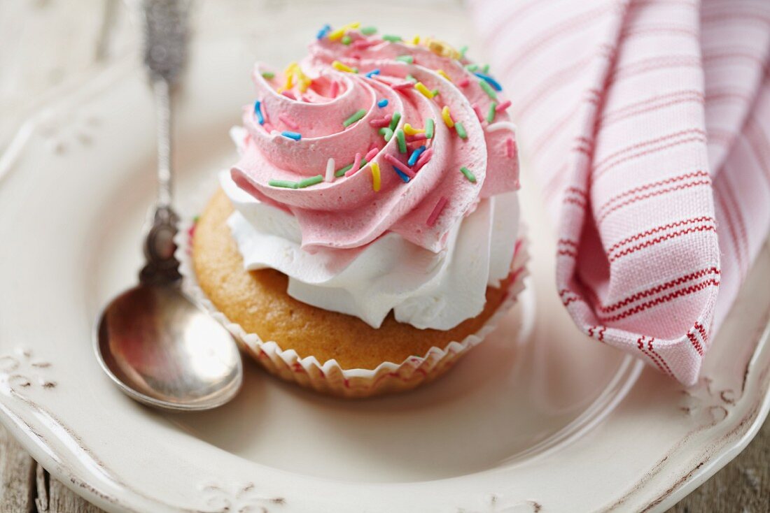 A cupcake with colourful sugar sprinkles