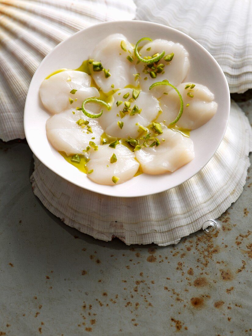 Carpaccio of scallops with pistachios and lime zest