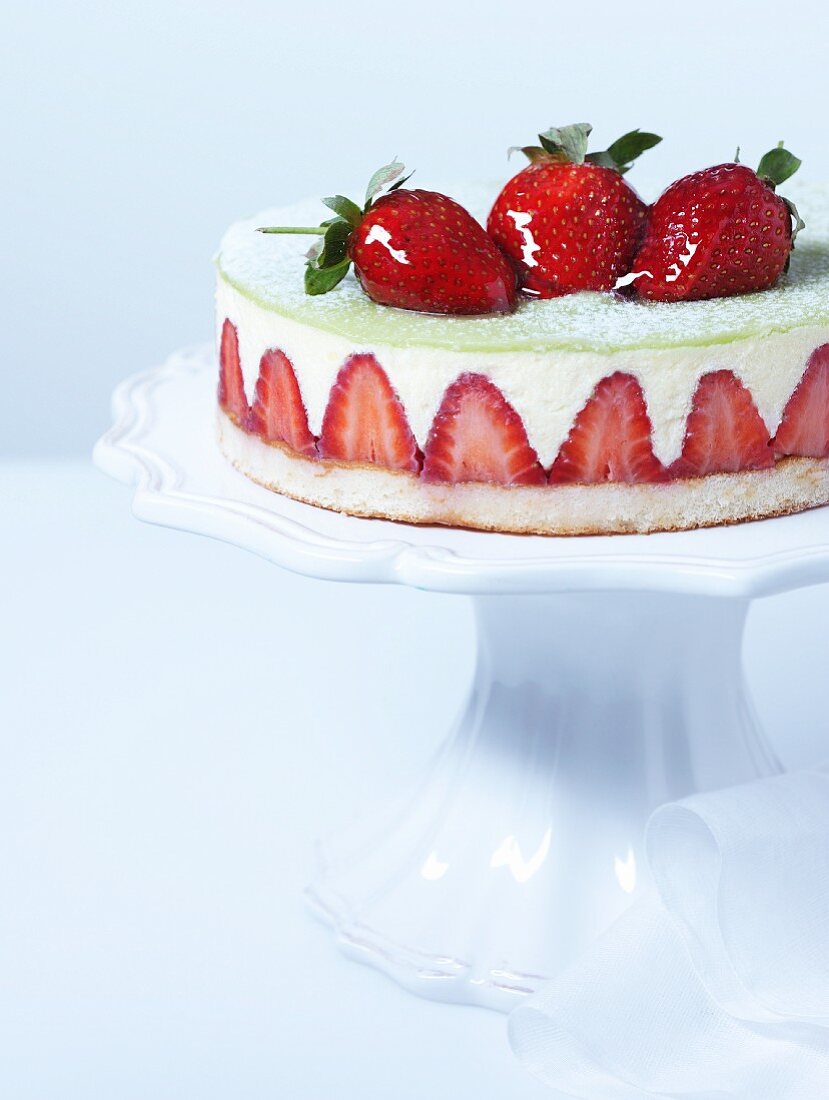Cheesecake with strawberries on a torte stand