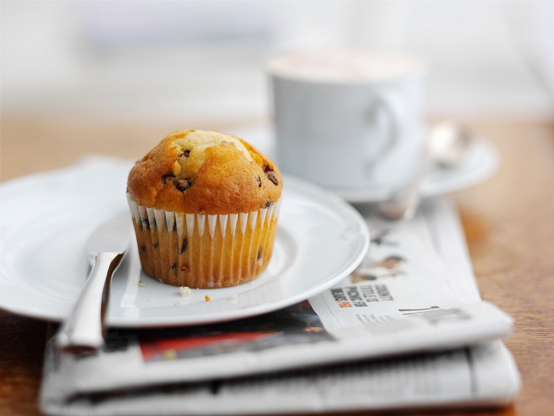 A muffin with a cup of coffee for breakfast