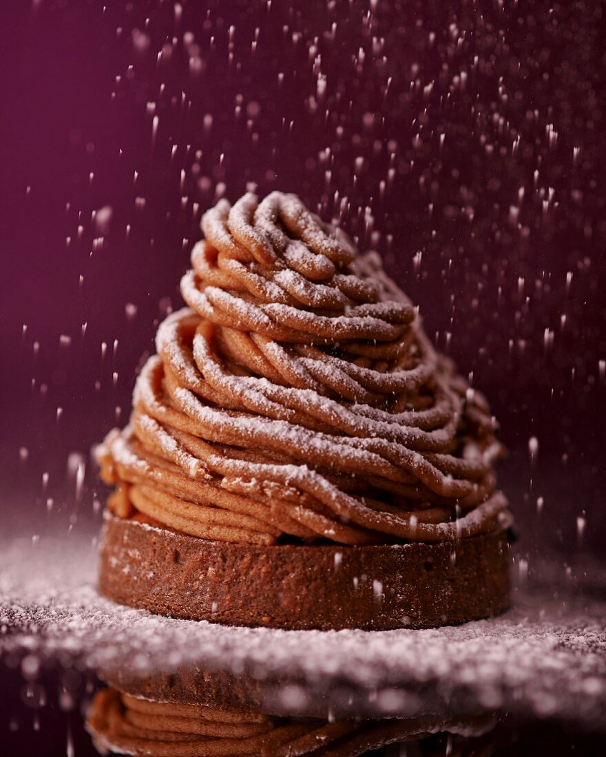 Individual chestnut cream torte with meringue and icing sugar