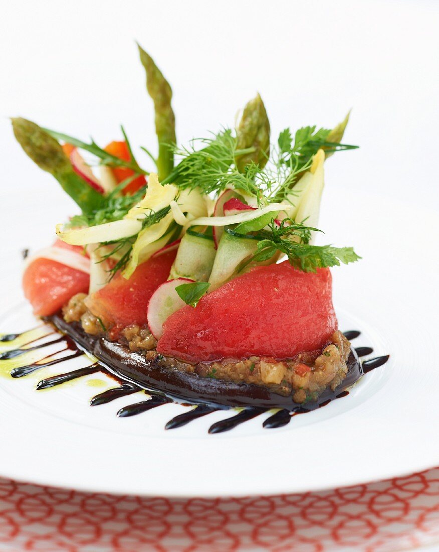 Tomatoes, cucumbers and asparagus on vegetable tartar