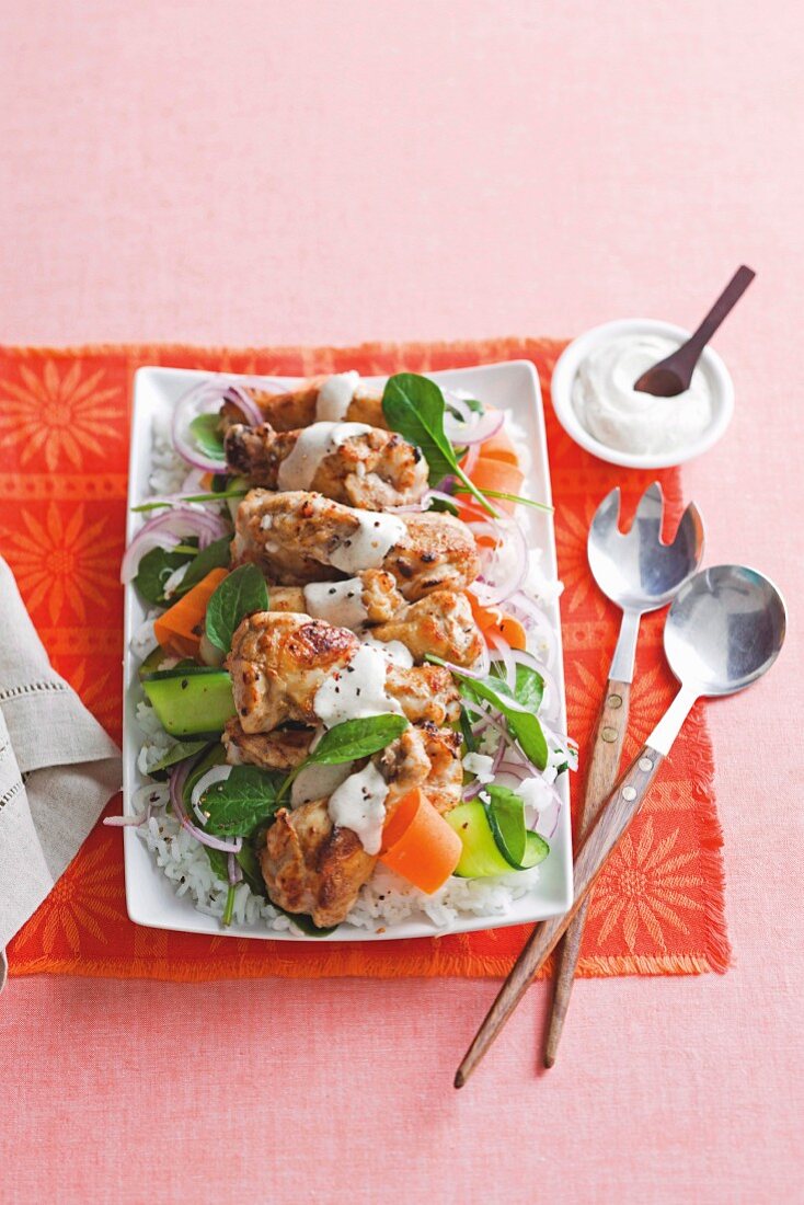 Chicken drumsticks on a bed of salad, with salt and pepper