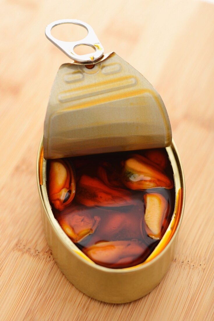 Marinated mussels in an opened tin