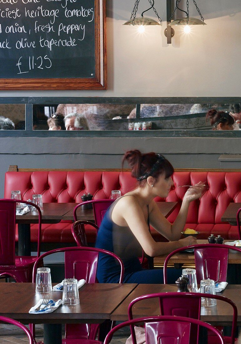 A woman eating in a Jamie's Italian restaurant in Cheltenham, England