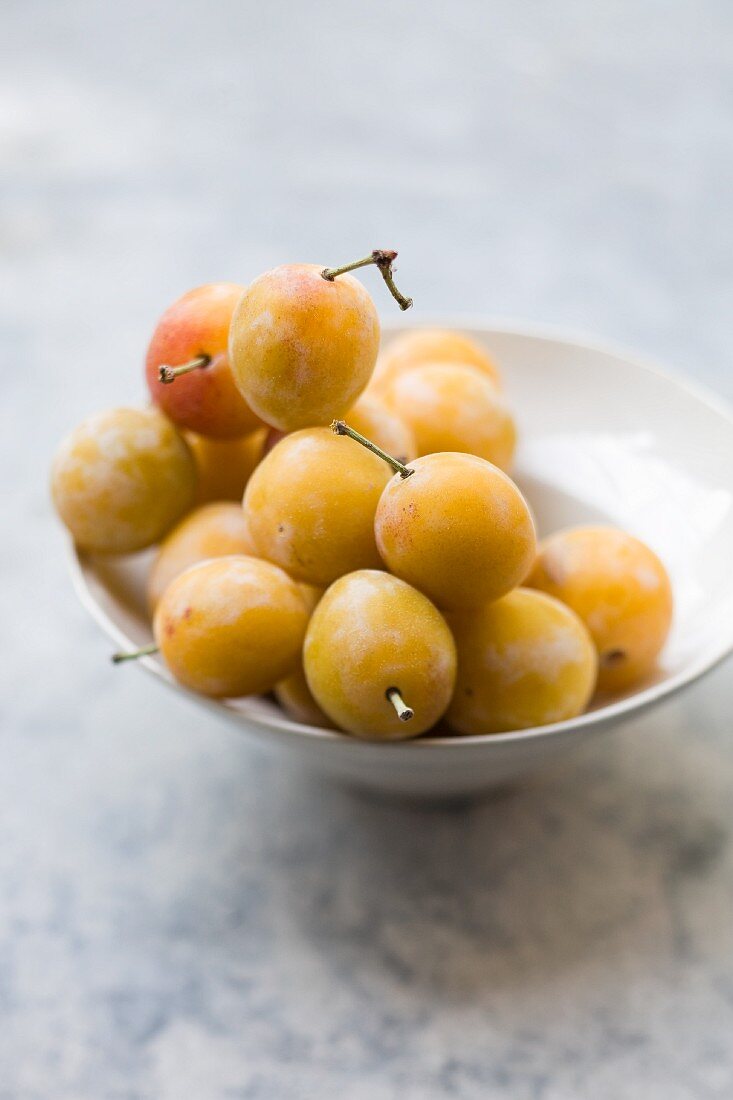 Several Mirabelle plums in a bowl