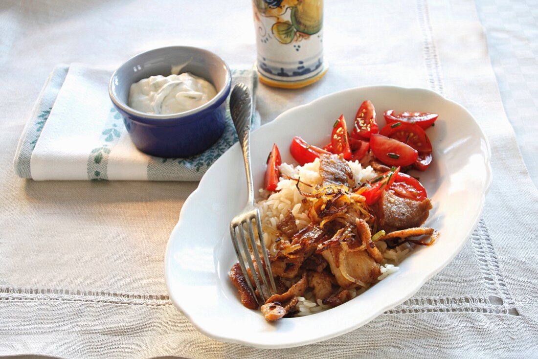 Fried gyro (Greek kebab meat) with rice and peppers