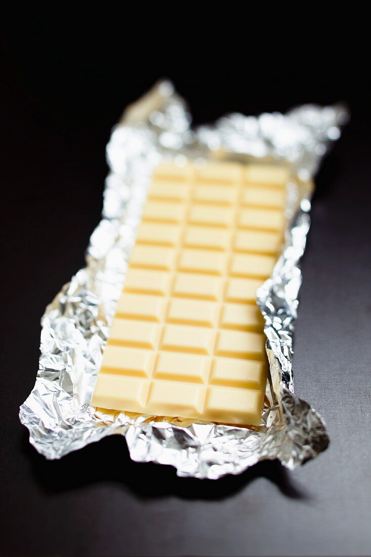 A bar of white chocolate in silver foil