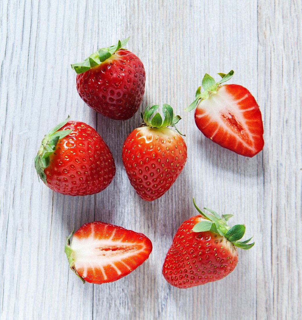 Strawberries on a wooden slab, viewed from above