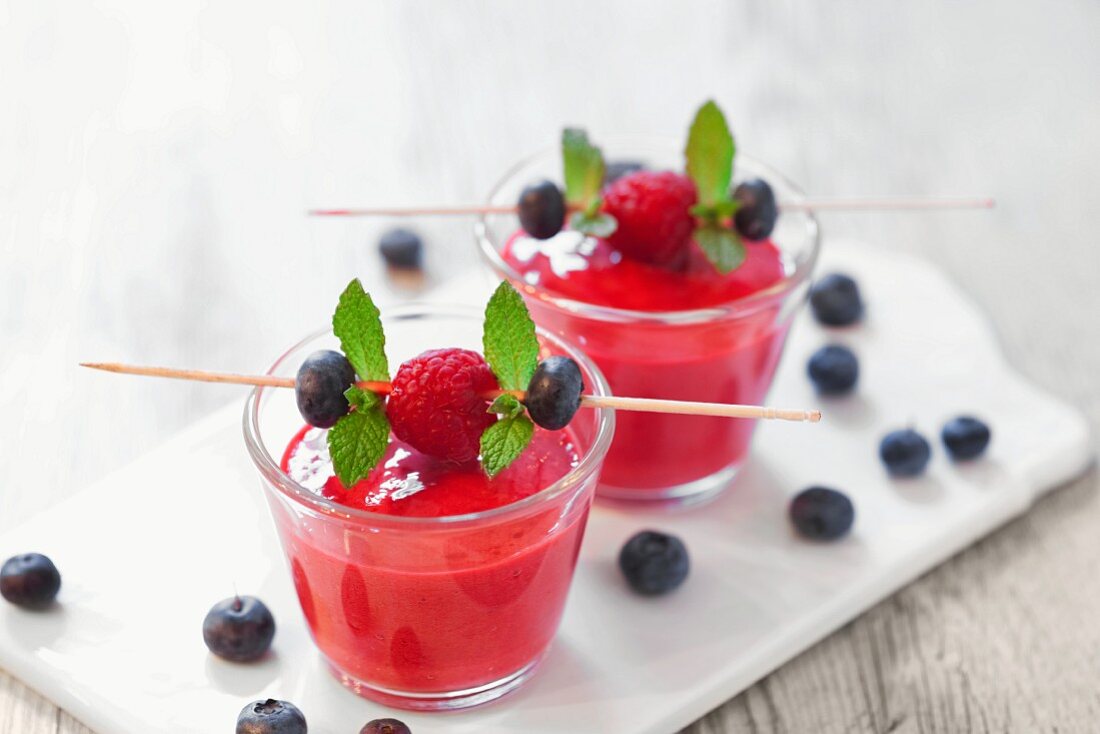 Raspberry and blueberry smoothies on a chopping board