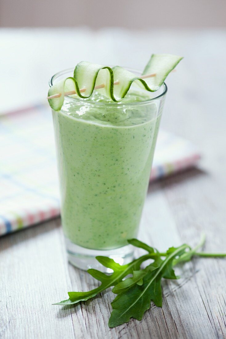Rocket and cucumber smoothie on a wooden tabletop