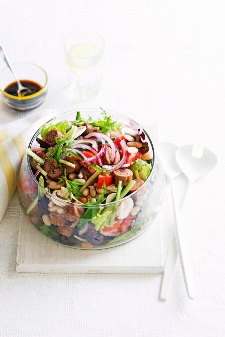 Vegetable salad with beans, mushrooms and sausage