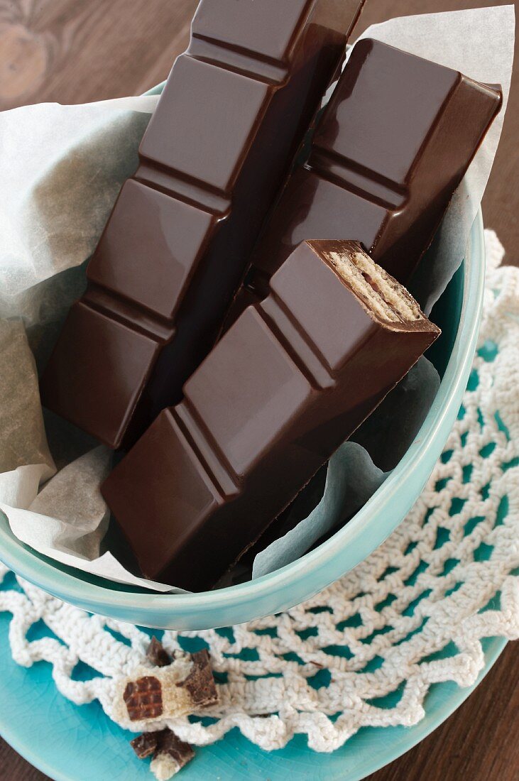 Bars of chocolate on paper in a bowl