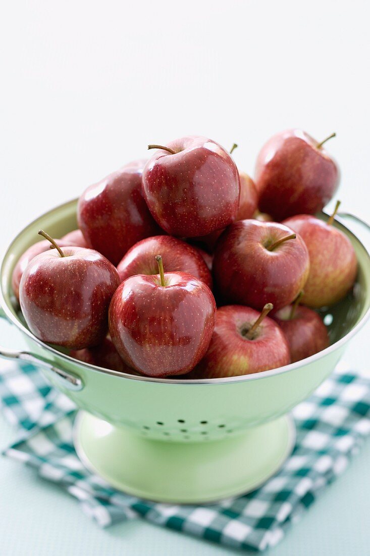 Lots of red apples in a colander