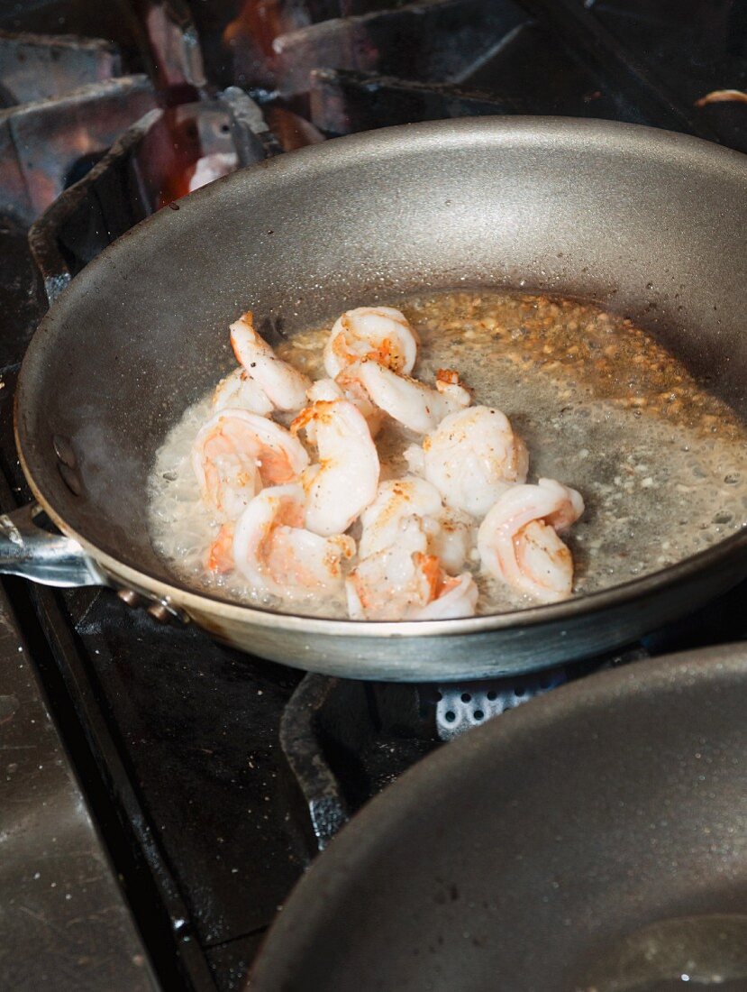 Prawns being fried in a pan