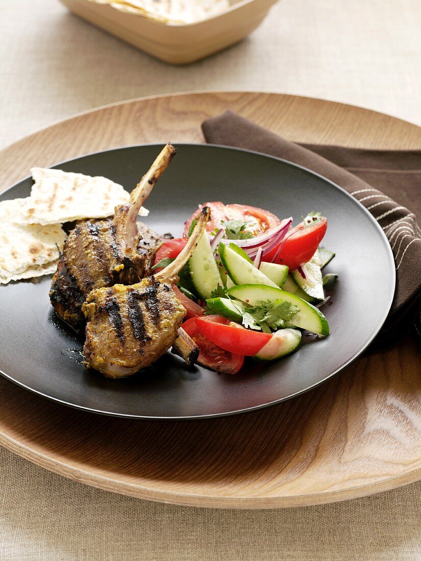 Grilled lamb chops with vegetable salad and flatbread