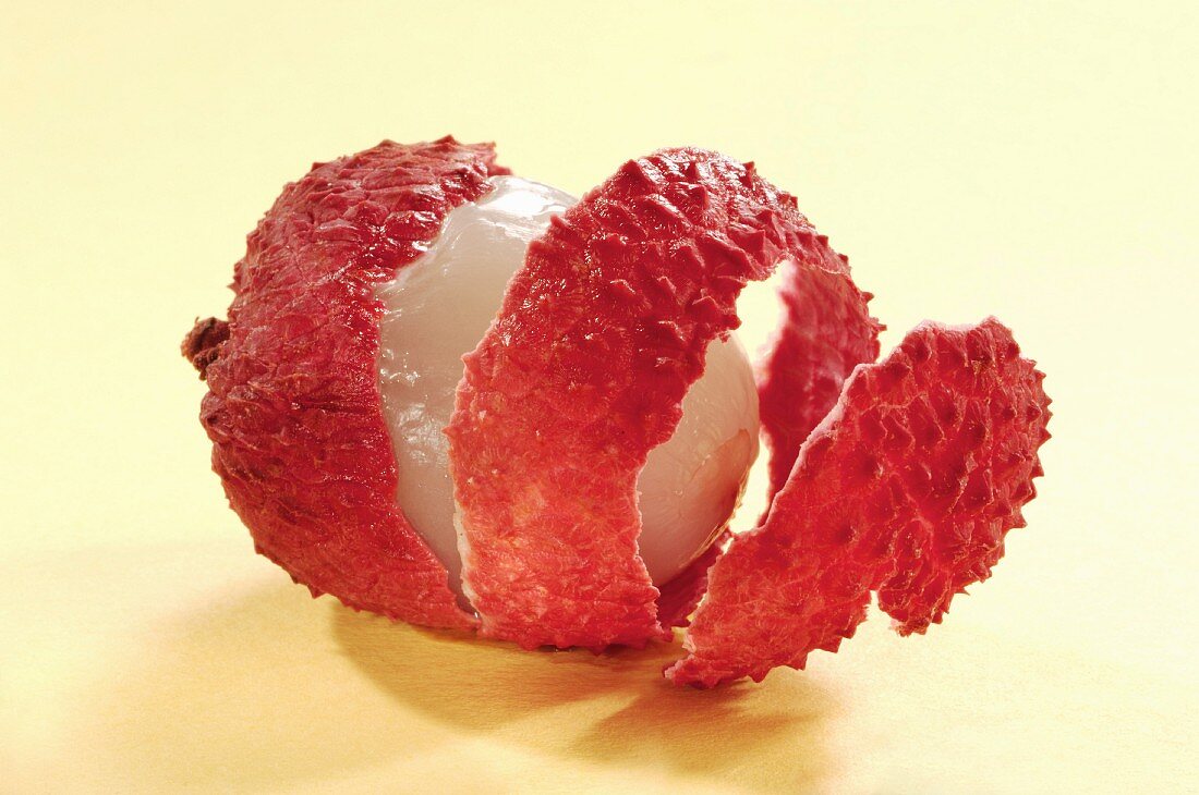 A lychee, peeled in a spiral