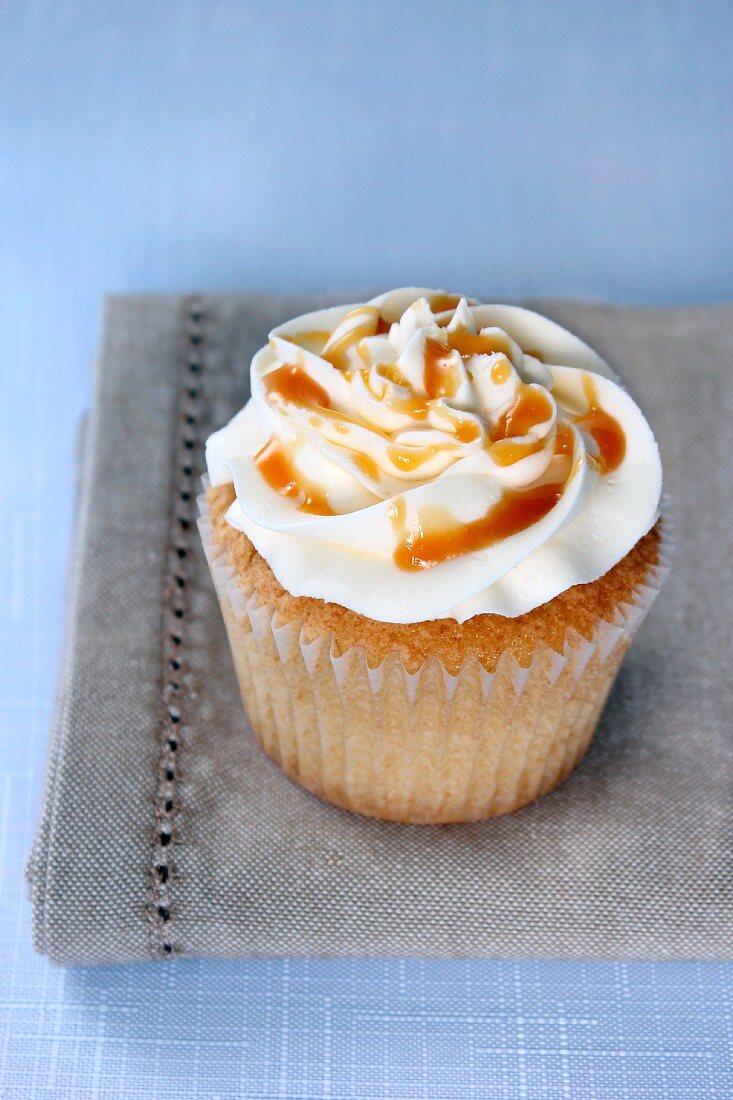 A vanilla cupcake with salted caramel sauce