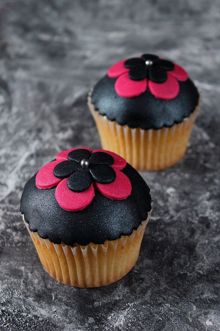 Cupcakes topped with black fondant icing