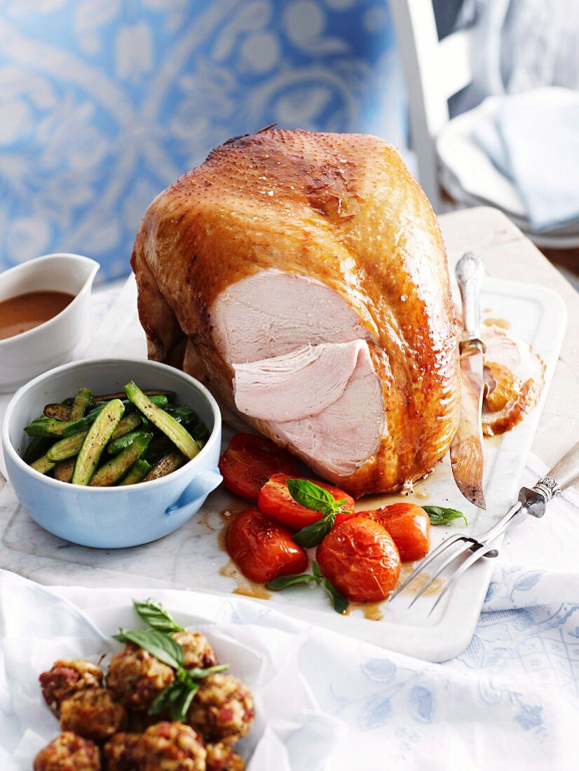 Partly sliced roast turkey, with pancetta stuffing