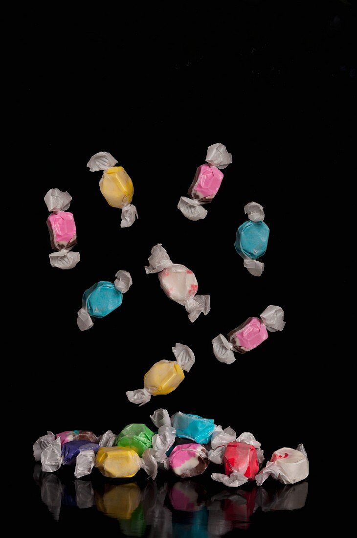 Colourful sweets falling to the ground
