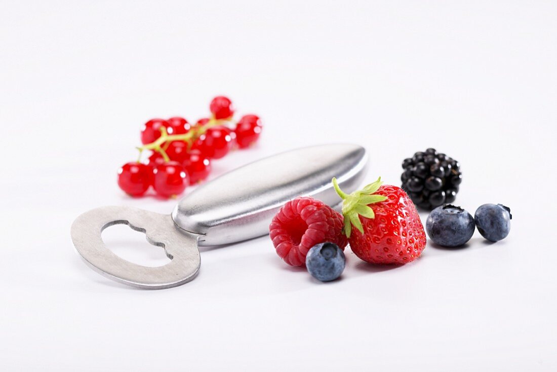 A bottle opener and fresh berries
