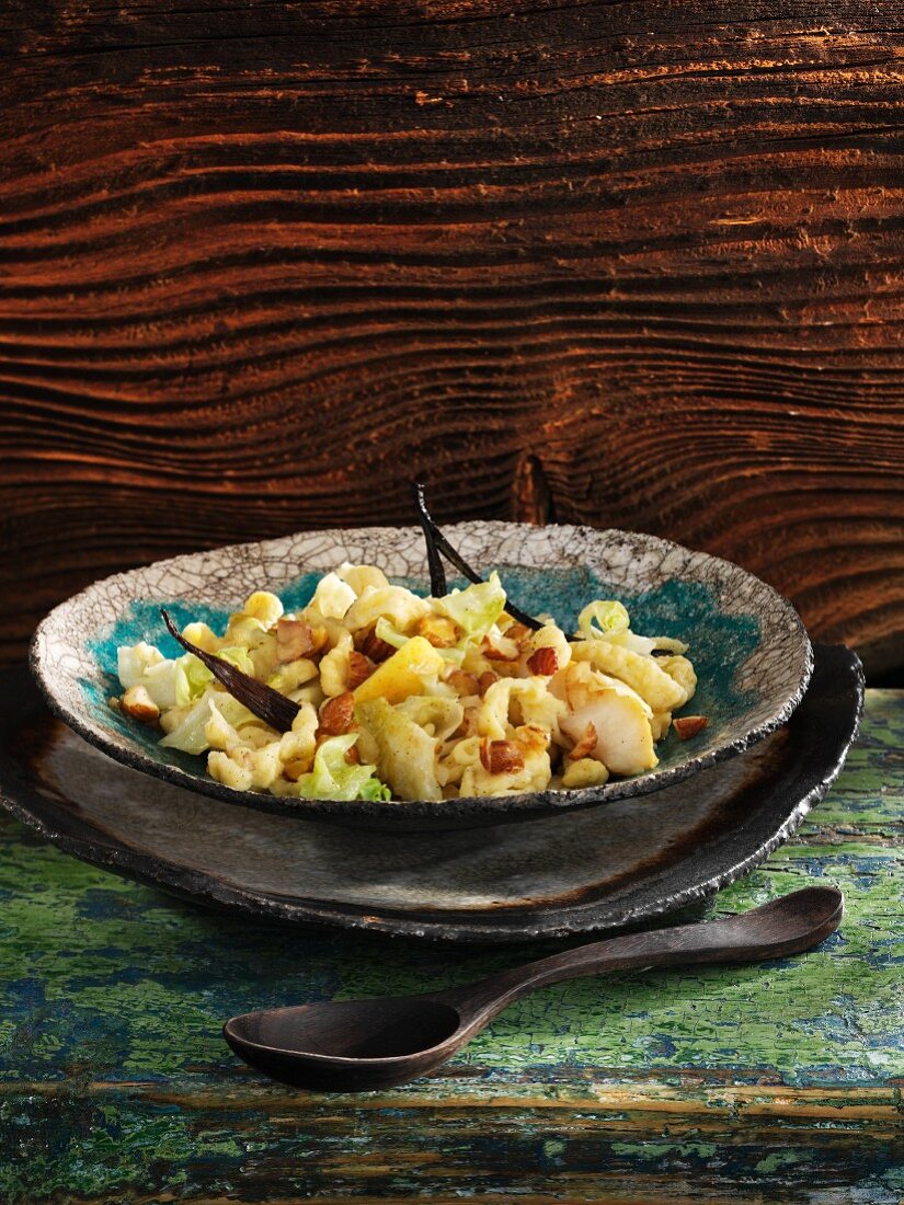 Vanilla spätzle (soft egg noodles from Swabia) with pointed cabbage, pears and hazelnuts