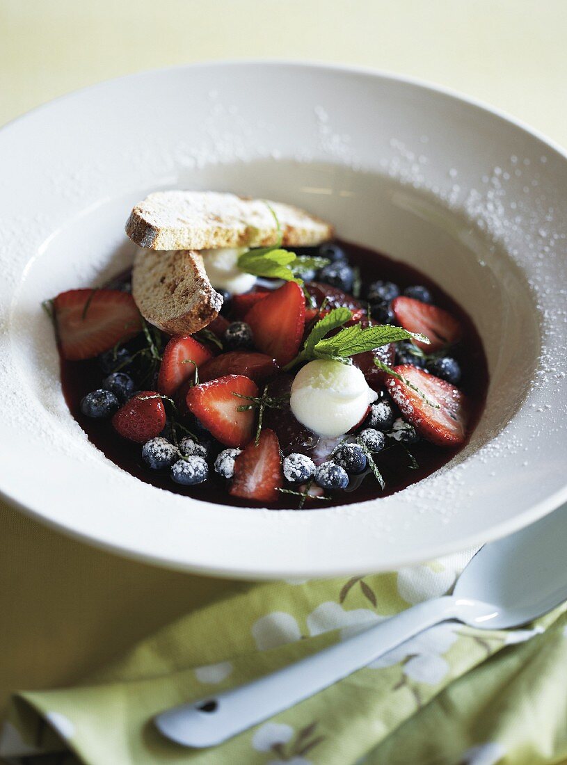 Red wine and peach soup with berries