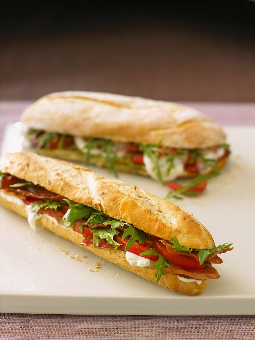 Baguette sandwiches filled with tomato, mozzarella and rocket