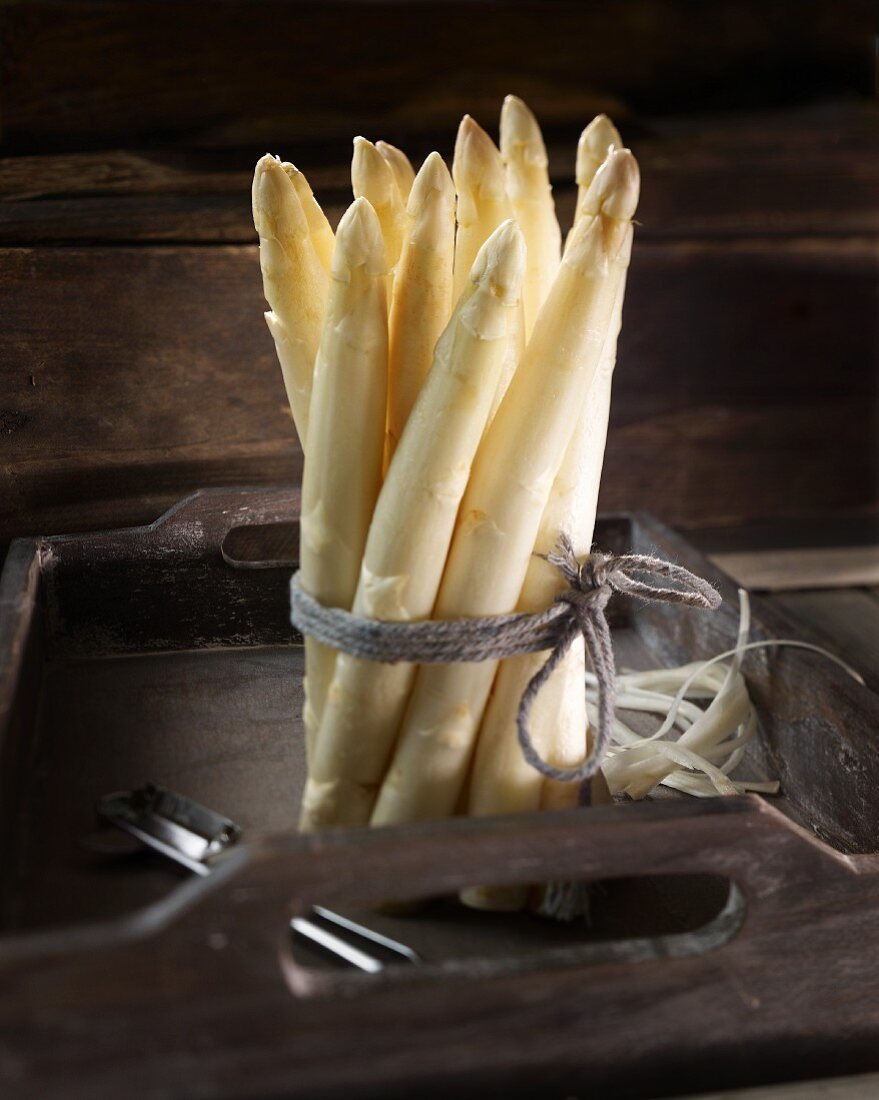 A bunch of white asparagus on a wooden tray